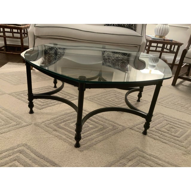 1970s hexagon black metal and glass coffee table. This chic accent piece pairs the coolness of painted black metal with...