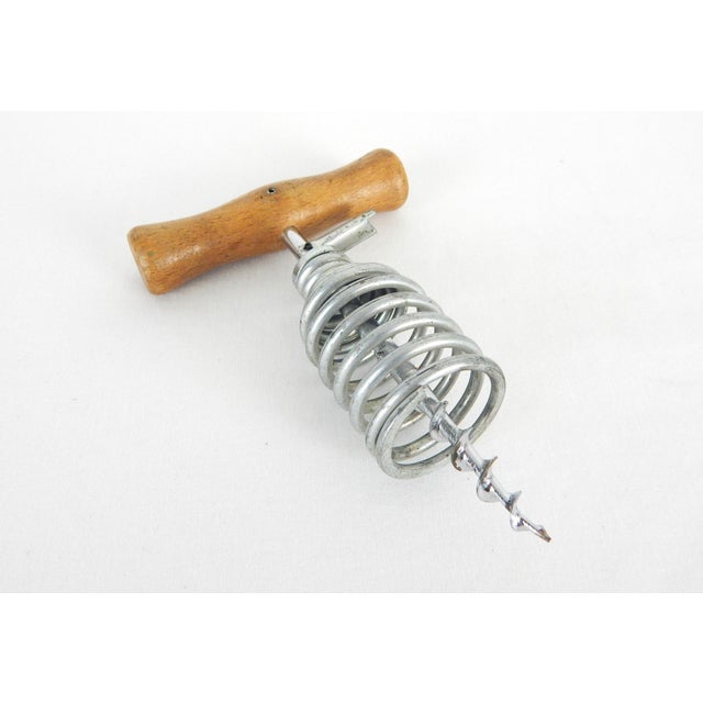 Vintage Italian spring-corkscrew with wood handle, circa-1950s. Lettering on handle reads: "Gira E Stoppa" translating to...