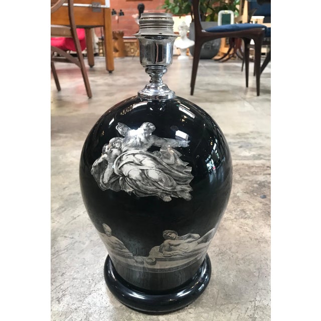 This is a vintage table lamp in the style of Fornasetti with "Michelangelo works" motifs and images, circa 1980. The piece...