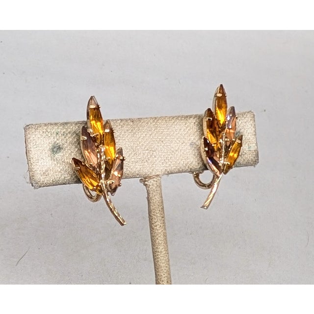 1960s goldtone prong set marquise faux-citrine & faux-topaz leaf clip back earrings. Marked "NAPIER©" Measure: 1 1/4...