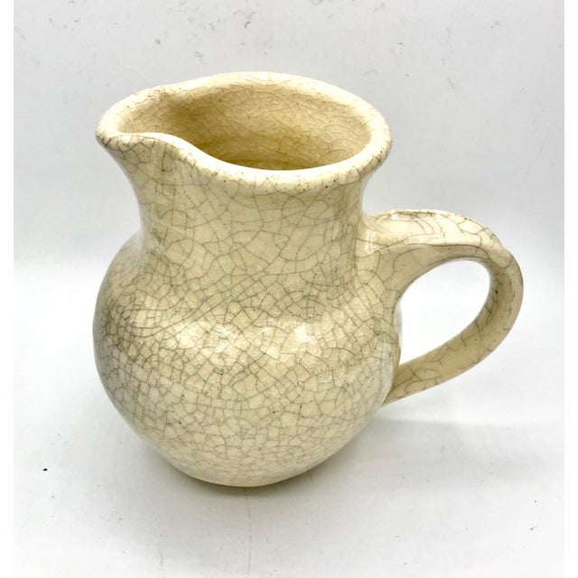 Lovely hand made studio pottery creamer with an asian inspired crackle glaze.