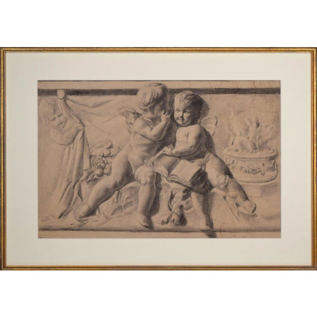 Antique graphite drawing of a cherub freeze, presented in cream colored matting and a parcel gilt wood frame. From a...