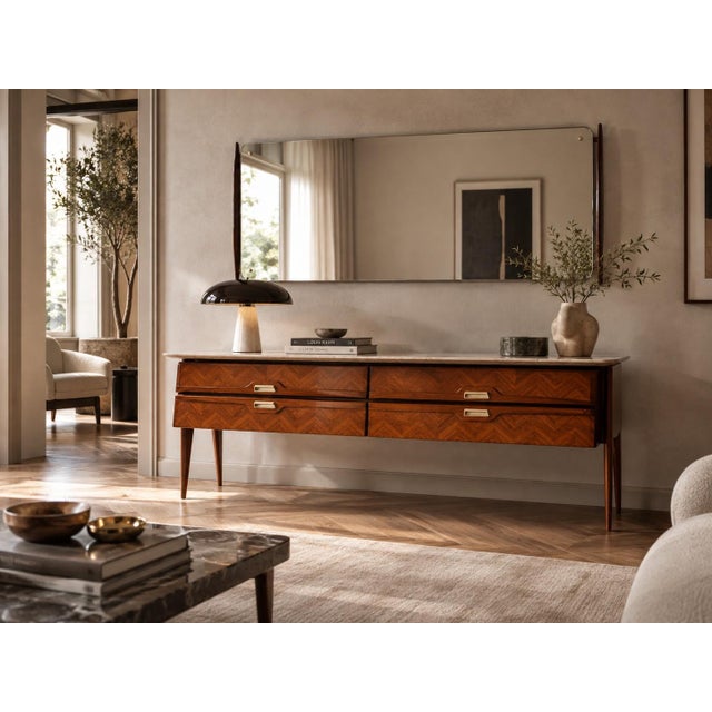 This elegant Italian sideboard or chest of drawers with matching mirror, by La Permanente Mobili Cantù, reflects the...
