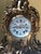 A 19th century impressive ormolu french mantle clock the ribbon arch over seated cherub with floral garland in the rococo...