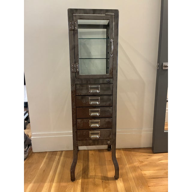 From RH description: "Our reproduction of a 19th-century pharmacy cabinet offers display-case storage for the bath."...