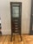 From RH description: "Our reproduction of a 19th-century pharmacy cabinet offers display-case storage for the bath."...