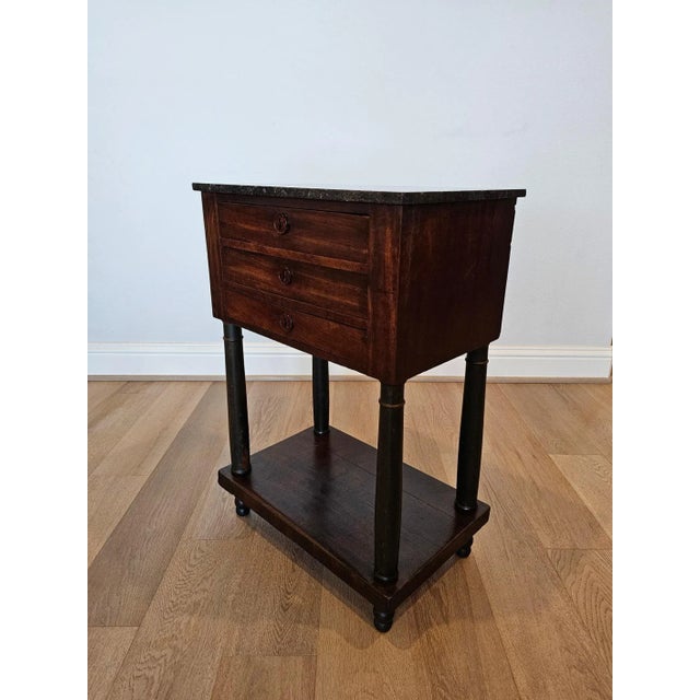A scarce period French Empire (1804-1815) mahogany chest of drawers nightstand with beautifully aged patina. Born in...