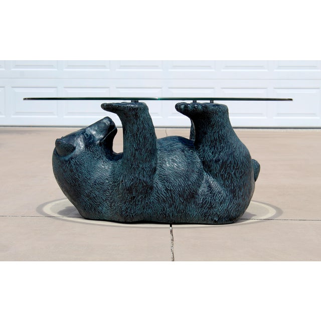 Bring rustic charm and conversation-starting style to your home with this striking vintage black bear coffee table....