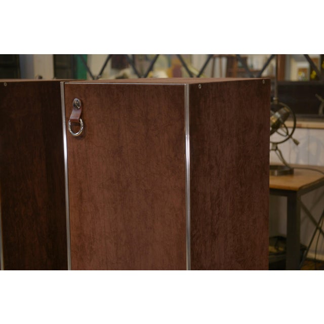 Pair of wardrobes designed by Guido Faleschini, produced by Mariani for Hermès, 1970s. The deliberately monolithic forms...