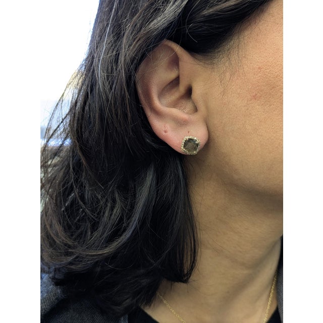 Elevate your everyday elegance with these stunning sapphire stud earrings. Each piece features a natural 8mm cushion-cut...