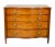 Serpentine top over four graduated drawers flanked by reeded columns. Brass ring handles on drawers , raised on circular...