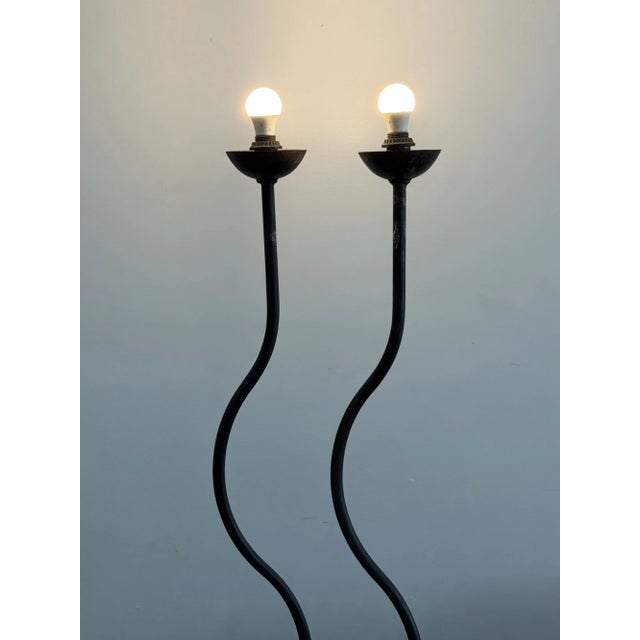 Base W21 Height 67.5 Artisanal floor lamps featuring hand-forged iron frames with a distinct undulating silhouette. The...