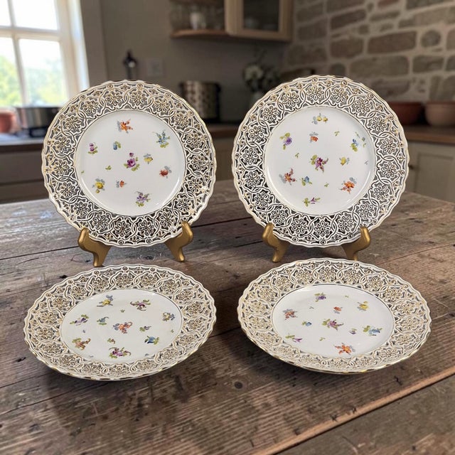 This set of 4 vintage Saxonia Dresden painted floral gilded reticulated 8'' plates is a charming addition to any table...