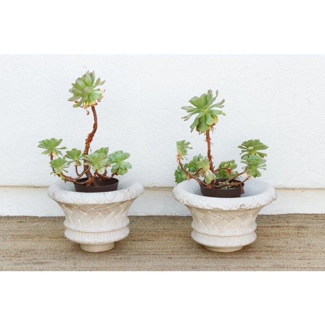 Attributed to the mid 20th century, this matching pair of hand-carved solid white marble jardinieres exemplifies the...