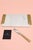 Michael Aram cheese board featuring a white marble surface with textured gold-tone handles from the Safari Collection. The...
