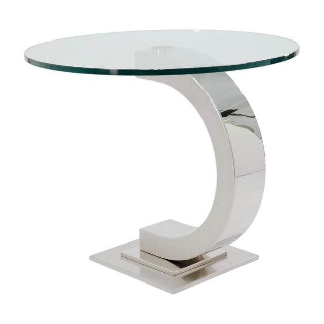 A blend of sculptural form and refined materials, this curved modernist side table makes a bold yet versatile statement....