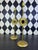 Pair of tall vintage gilt-metal candlesticks featuring dimensional sunburst medallions with inset round mirrors. Slender...