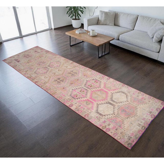 This authentic 1960s Eastern Anatolian runner rug is a stunning example of mid-century Turkish craftsmanship, featuring a...