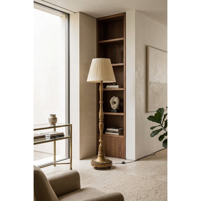 An elegant French floor lamp, crafted around 1940 from carved and gilded wood, designed in the style of Paul Follot. The...