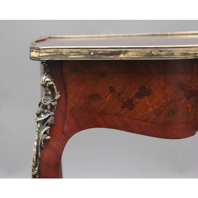 A freestanding 19th Century French Kingwood and marquetry side table, the shaped top decorated with floral marquetry and...