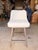 Contemporary swivel counter stool featuring a sleek, tailored silhouette upholstered in soft ivory leather for a clean and...
