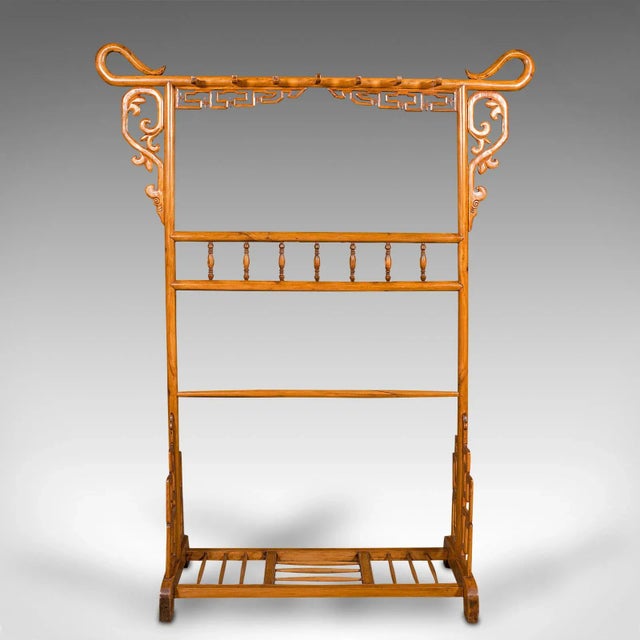 This is a tall antique carved hall stand. An Oriental, Chinese elm hat and coat rack, dating to the late Victorian period,...