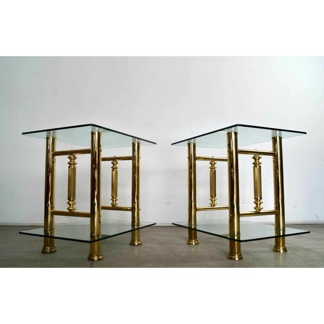 Pair of vintage Hollywood Regency Brass end tables for sale. They are solid and well built, and have thick solid glass and...