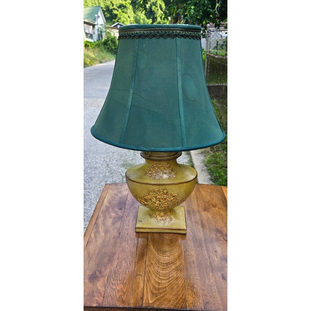 Bring timeless elegance to your home with this vintage Hollywood Regency-style table lamp. The decorative urn-shaped base...