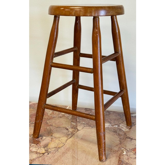 Vintage primitive farmhouse style wooden stool. Measures 21.5"H. Natural age wear. Sturdy structure.