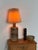 Danish table lamp in partially glazed stoneware, attributed to Tue Poulsen 1960s–1970s. The base is a bottle form, with a...
