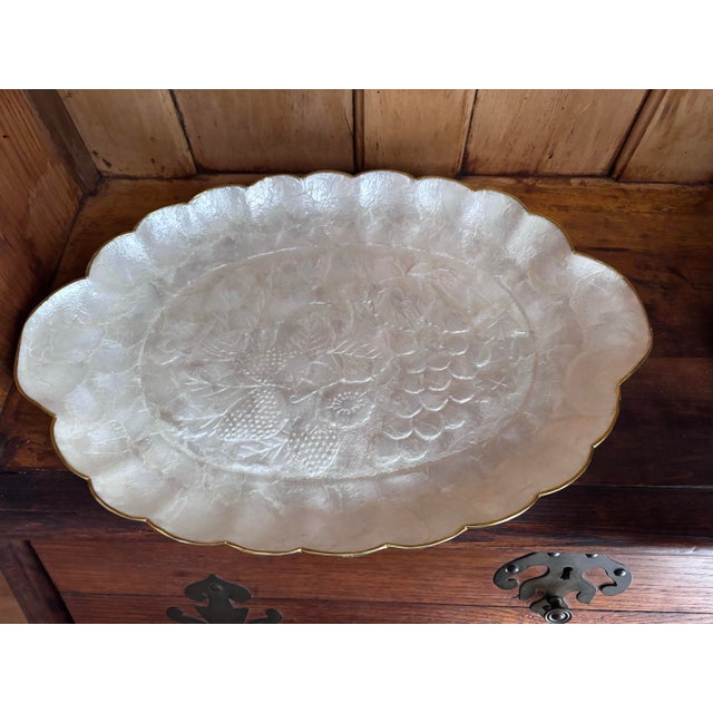 Decorative oval shaped tray with scalloped, gold edges. Made from capiz shell. Vintage and in excellent condition for age.