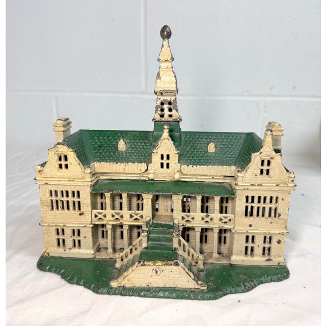 The rare antique 1890's Ives, Blakeslee & Company green and white painted cast iron "palace" still bank is a unique and...