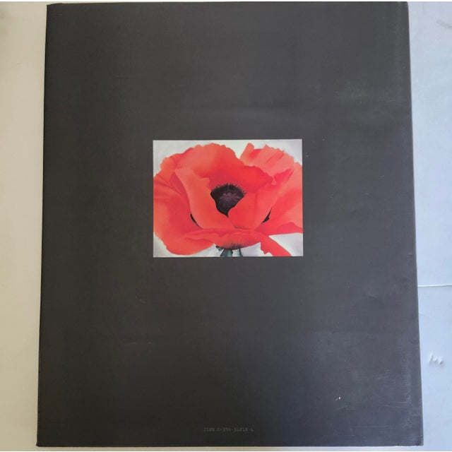 The product is a first edition hardcover book titled "Georgia O'Keeffe: One Hundred Flowers" published by Knopf Doubleday...