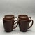 • This is a set of four vintage Corelle Stoneware coffee mugs featuring a rich, solid chocolate brown glaze. These durable...