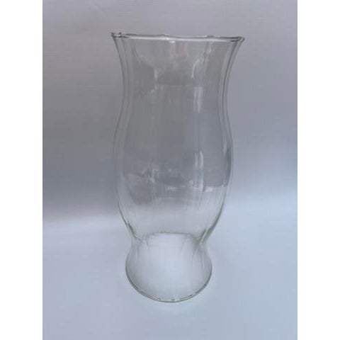 A single vintage clear hourglass shaped glass candle hurricane shade with subtle vertical ribbed texture.