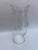 A single vintage clear hourglass shaped glass candle hurricane shade with subtle vertical ribbed texture.