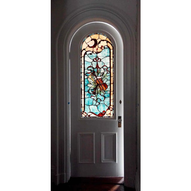 Antique, late-19th century, arched top, single door having corresponding stained and leaded glass upper panel. Beautiful,...