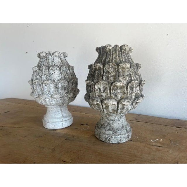 Pair of 19th century weathered stone artichoke finials. They are all hand chiseled and have bulbous shapes with a layered,...
