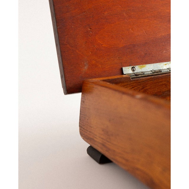 This wooden box features a finely crafted marquetry landscape depicting a mountain range, a winding path and a grazing...