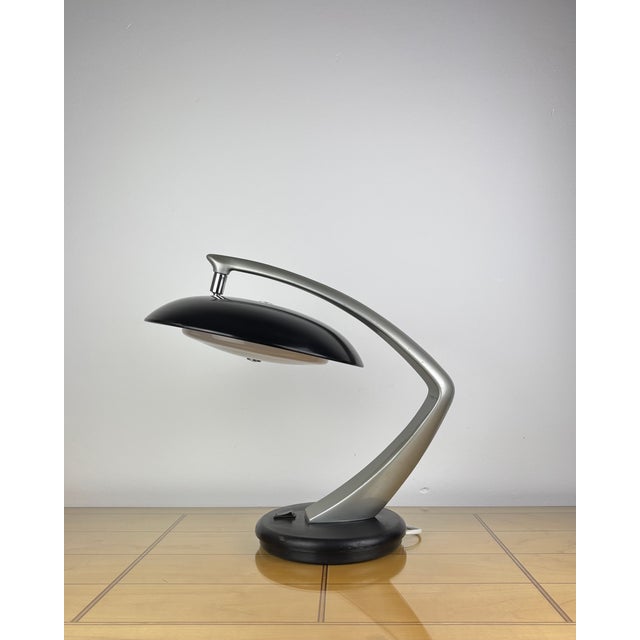 The fase boomerang 64 is an iconic mid-century modern table lamp that exemplifies spanish industrial design at its finest....