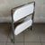 Practical and minimalist, this modernist folding bar cart features a polished chrome-plated metal frame and double,...
