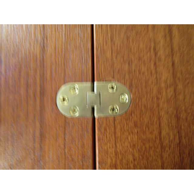 With a convertable hutch that folds down, multiple drawers for storage, and rich teak wood, this desk Attributed to Peter...