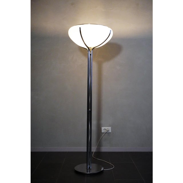 The Quadrifoglio floor lamp, designed by Gae Aulenti for Guzzini in the 1970s, features a chromed steel base with an...
