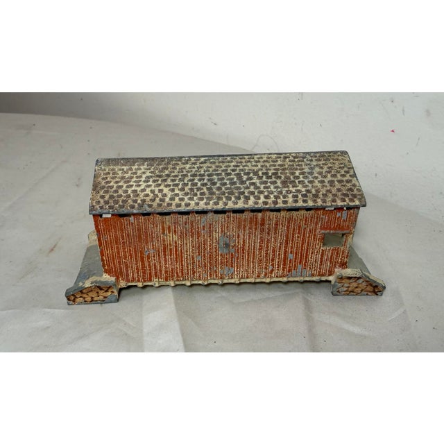 This vintage 20th century hand painted cast metal train bridge still bank is a unique and collectible piece originating...