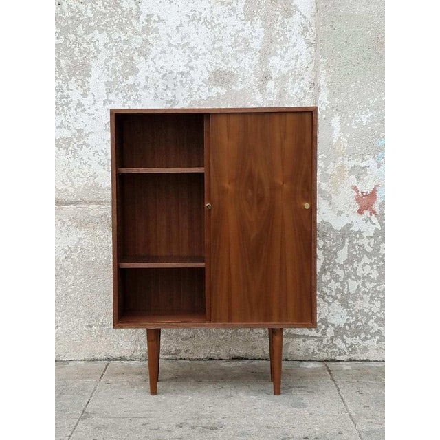 Inspired by Mid-Century Modern design, this stunning Exclusive Multi-Purpose Cabinet features handcrafted walnut wood,...