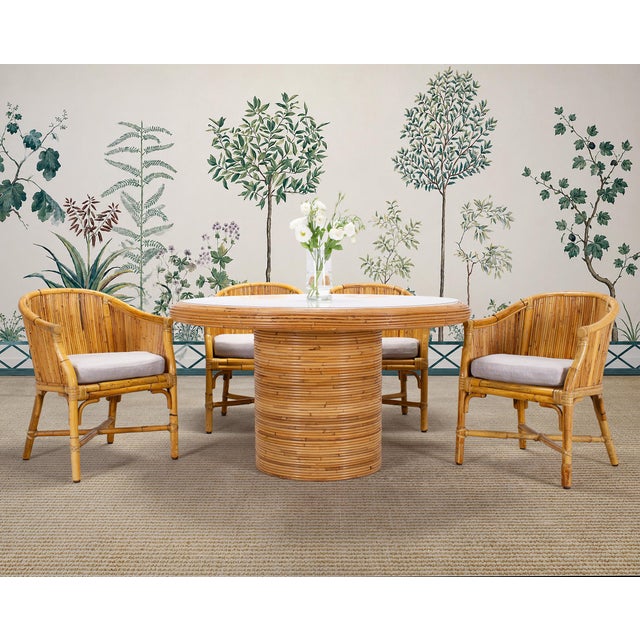 An exceptional labeled set of four rare barrel-back dining armchairs made by McGuire artisans in San Francisco, CA. This...