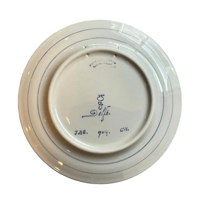 This is a 1968 Royal Delft hand-painted ceramic plate commemorating the Apollo 8 mission, titled "First Men Around the...
