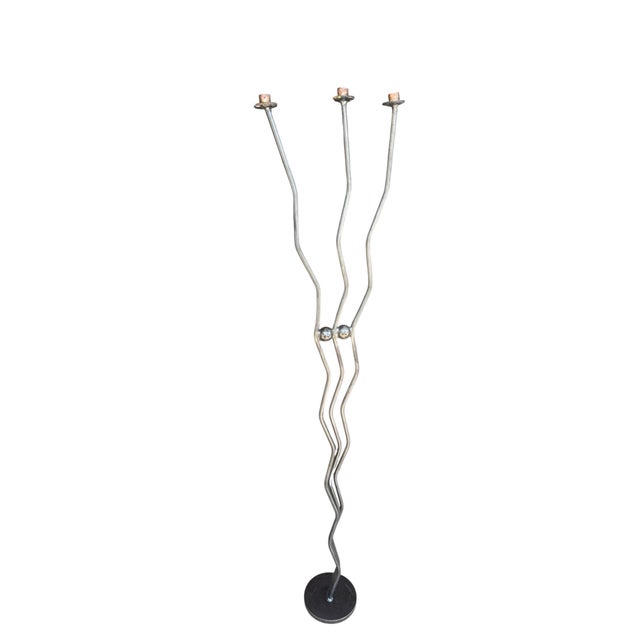 A striking vintage handmade brutalist floor candleholder crafted from wrought iron. This sculptural piece features three...