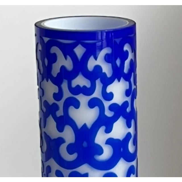 A luminous hand-carved cameo Peking Glass overlay vase in deep cobalt blue over milky white glass, created in China during...