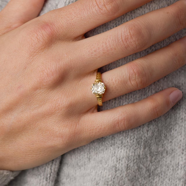 This elegant engagement ring showcases a captivating 2.02 carat old mine cut diamond, certified by GIA #1236769055,...